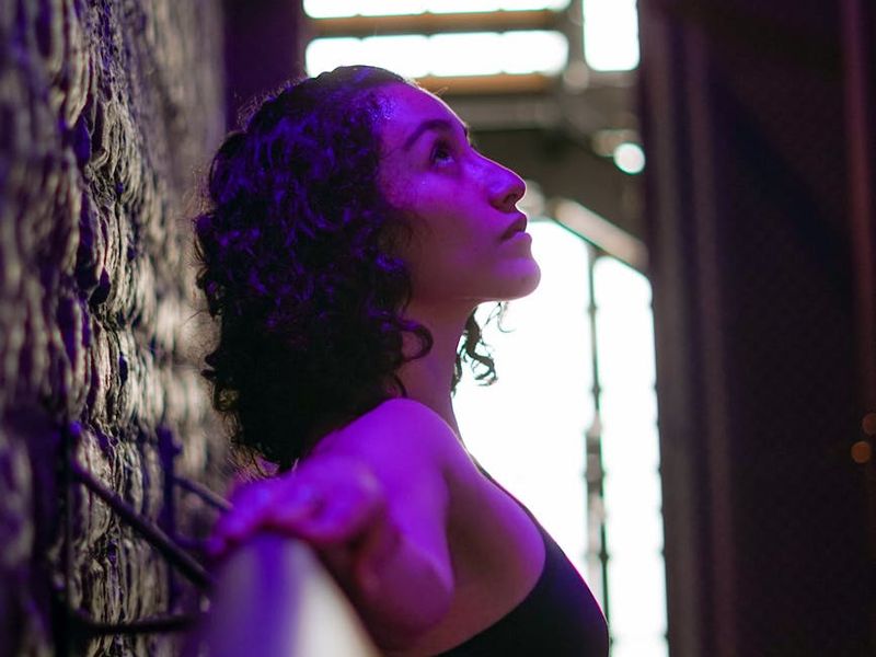 Minimalist yoga studio with purple ambient lighting