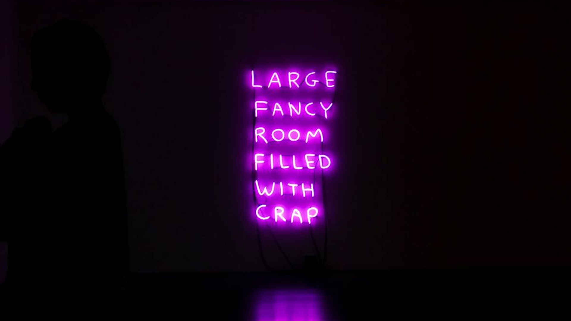 Person doing yoga in a dark room with purple neon lights